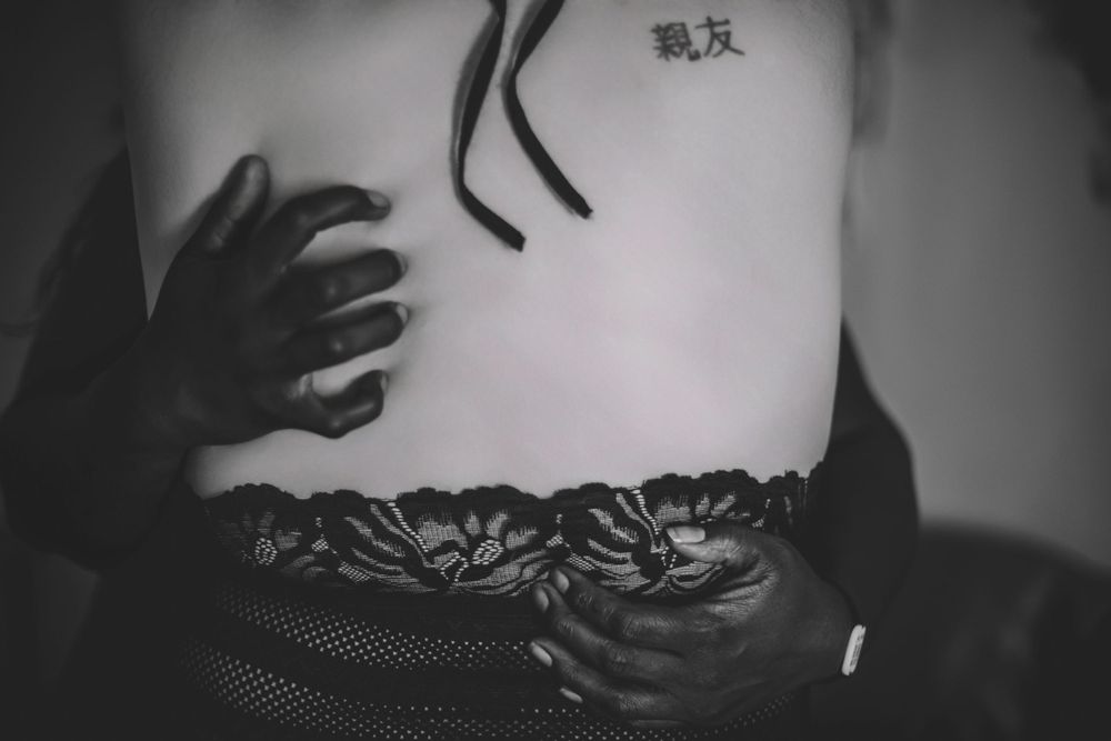 Artistic black and white closeup showing hands and lace details.