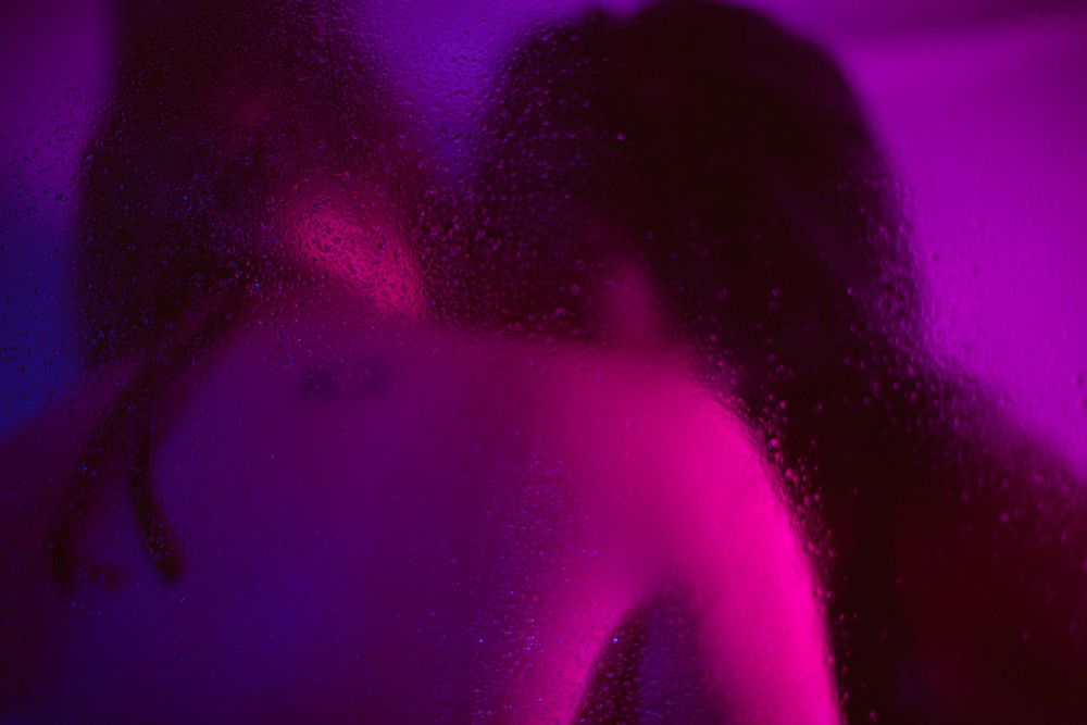 Abstract silhouettes in purple lighting creating atmospheric mood.