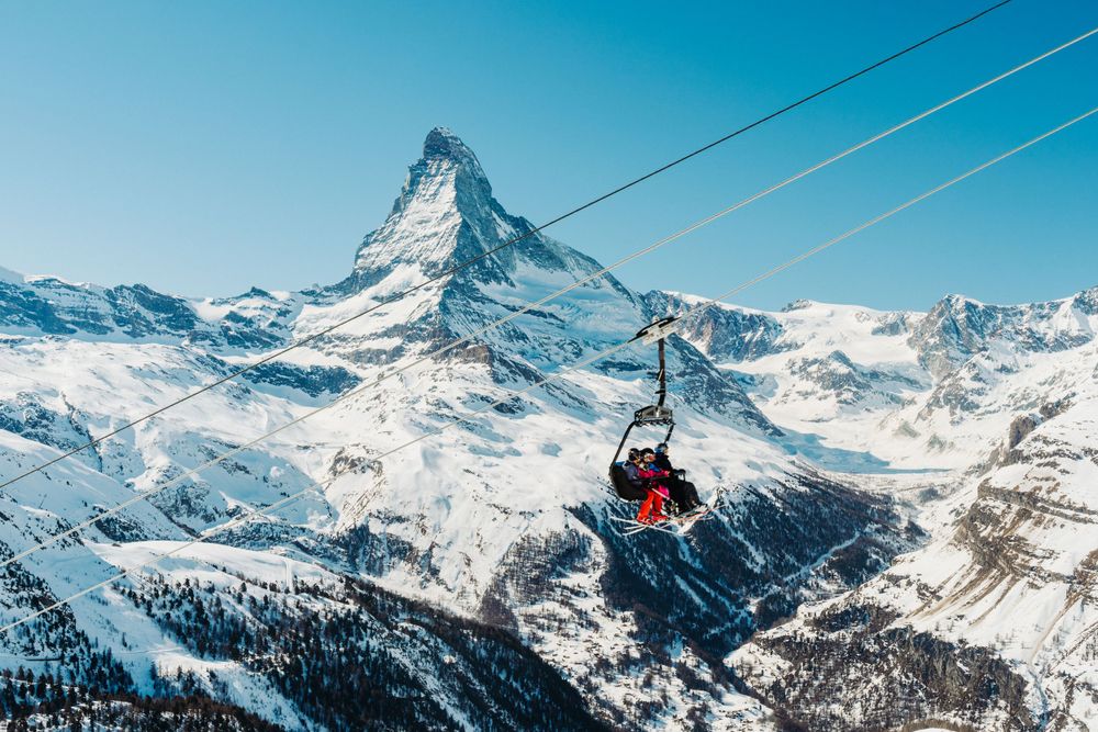 Cable car lines stretching across snowy mountain landscape with Matterhorn peak in background.