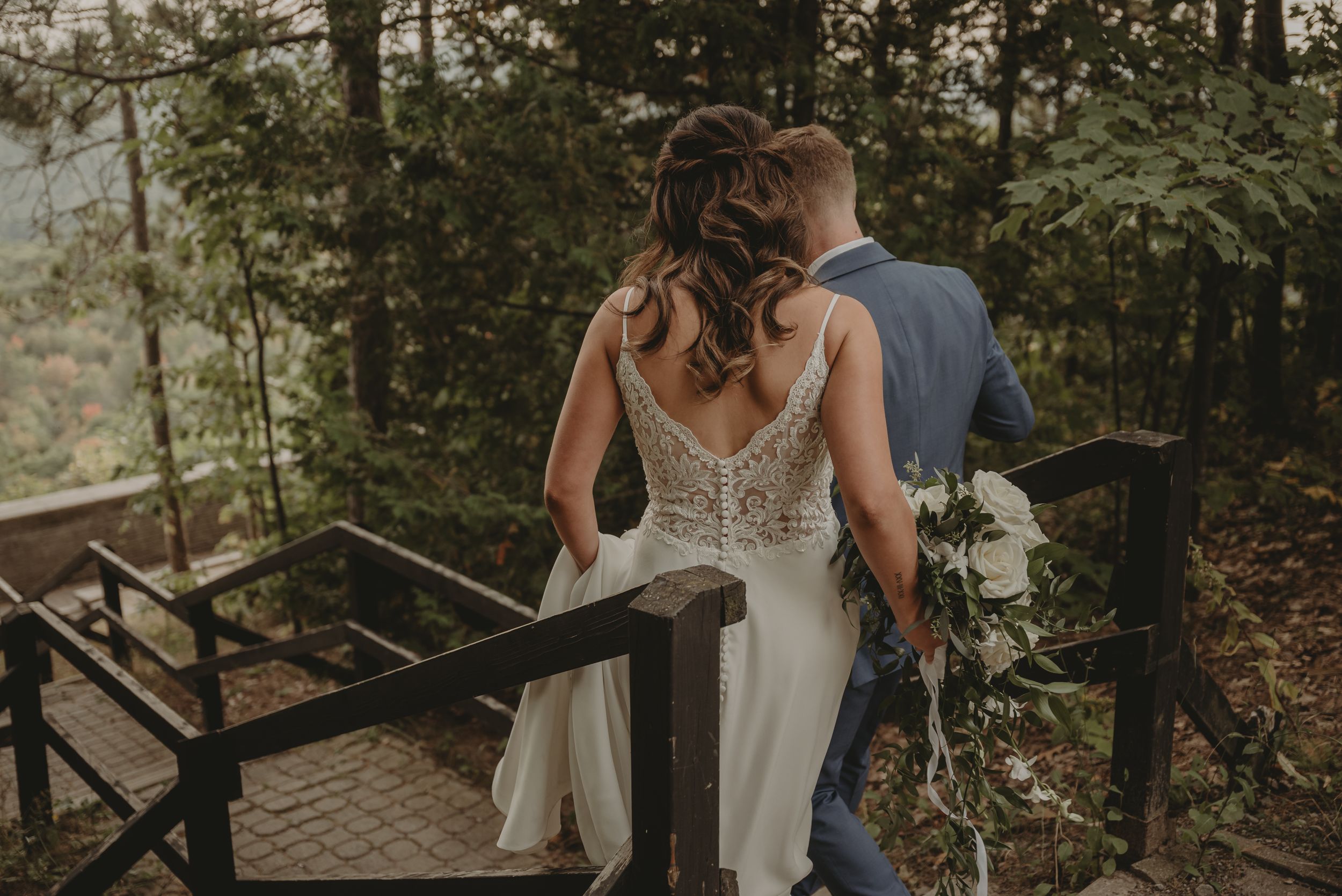 Romantic moment captured on a scenic overlook deck surrounded by forest.