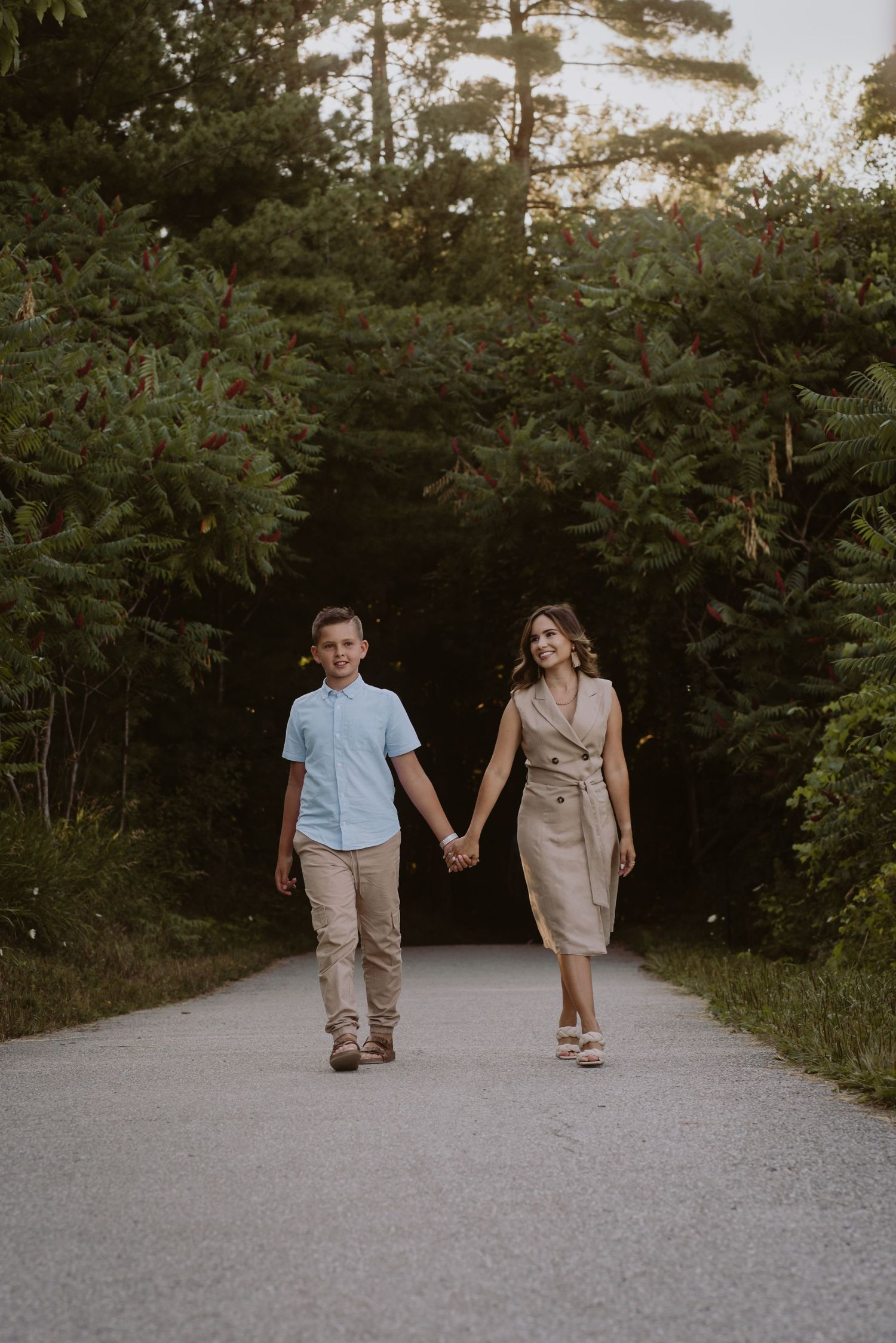 Image of mom and son walking down path.
