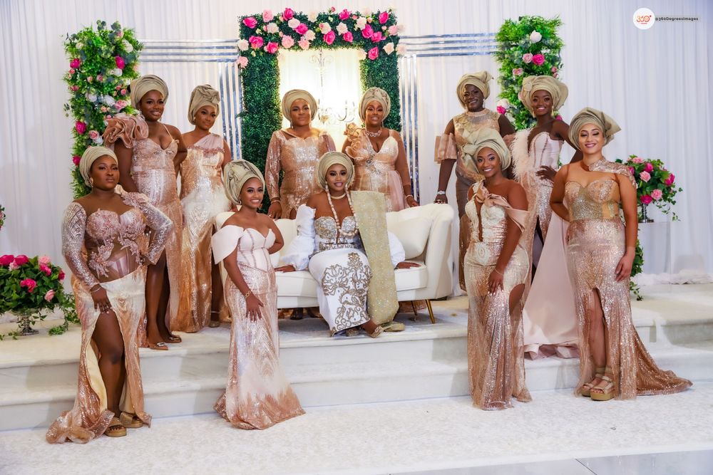 Nigerian bride surrounded by bridesmaids in rose gold sequin gowns at elegant traditional Yoruba wedding ceremony.