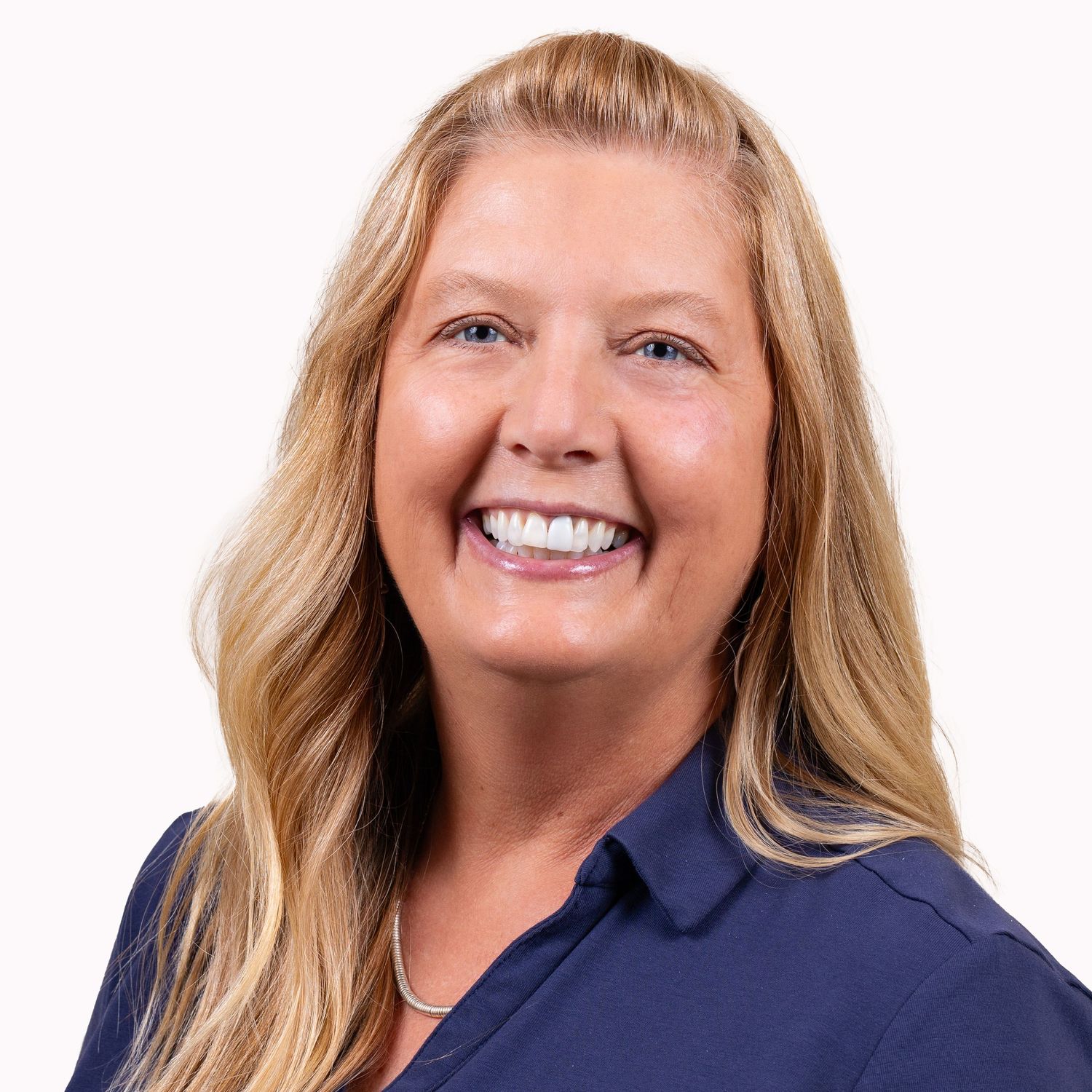 Professional headshots of a person in a navy blue collared shirt against white background.
