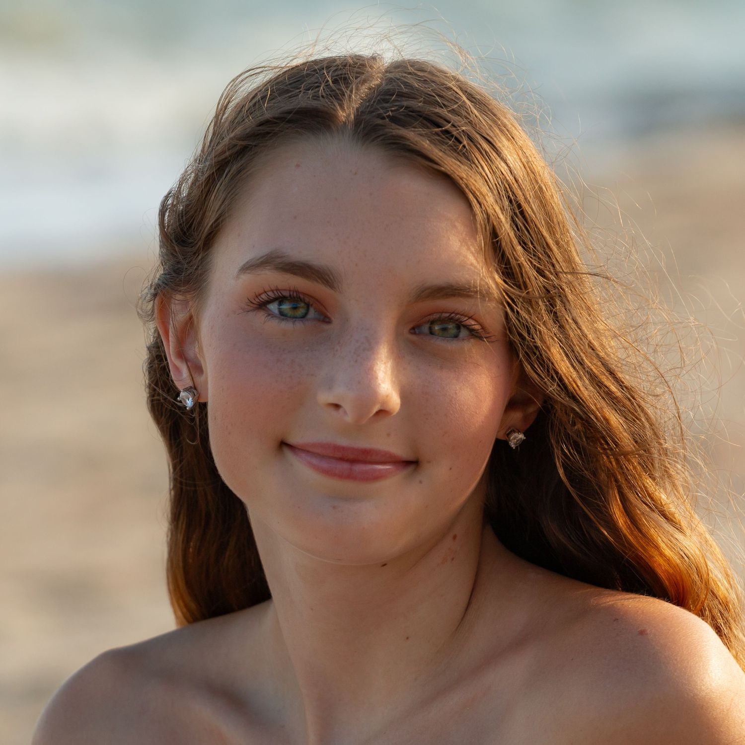 Outdoor portrait with soft lighting and natural backdrop capturing warm golden tones.