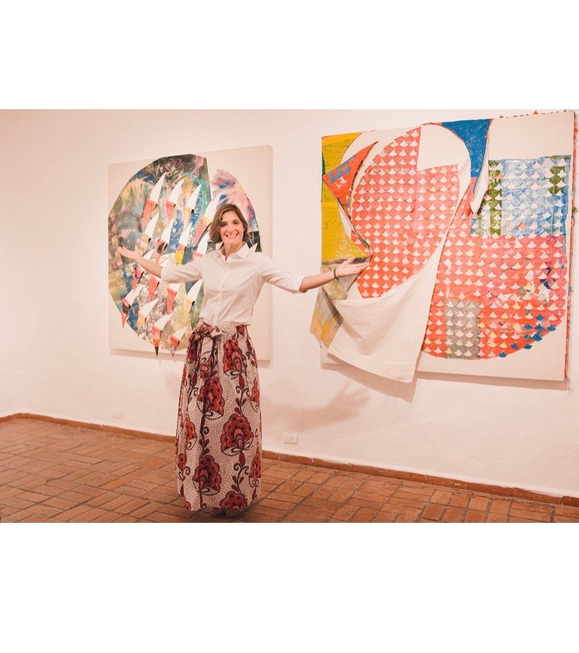 Art gallery interior showing colorful abstract paintings on display.