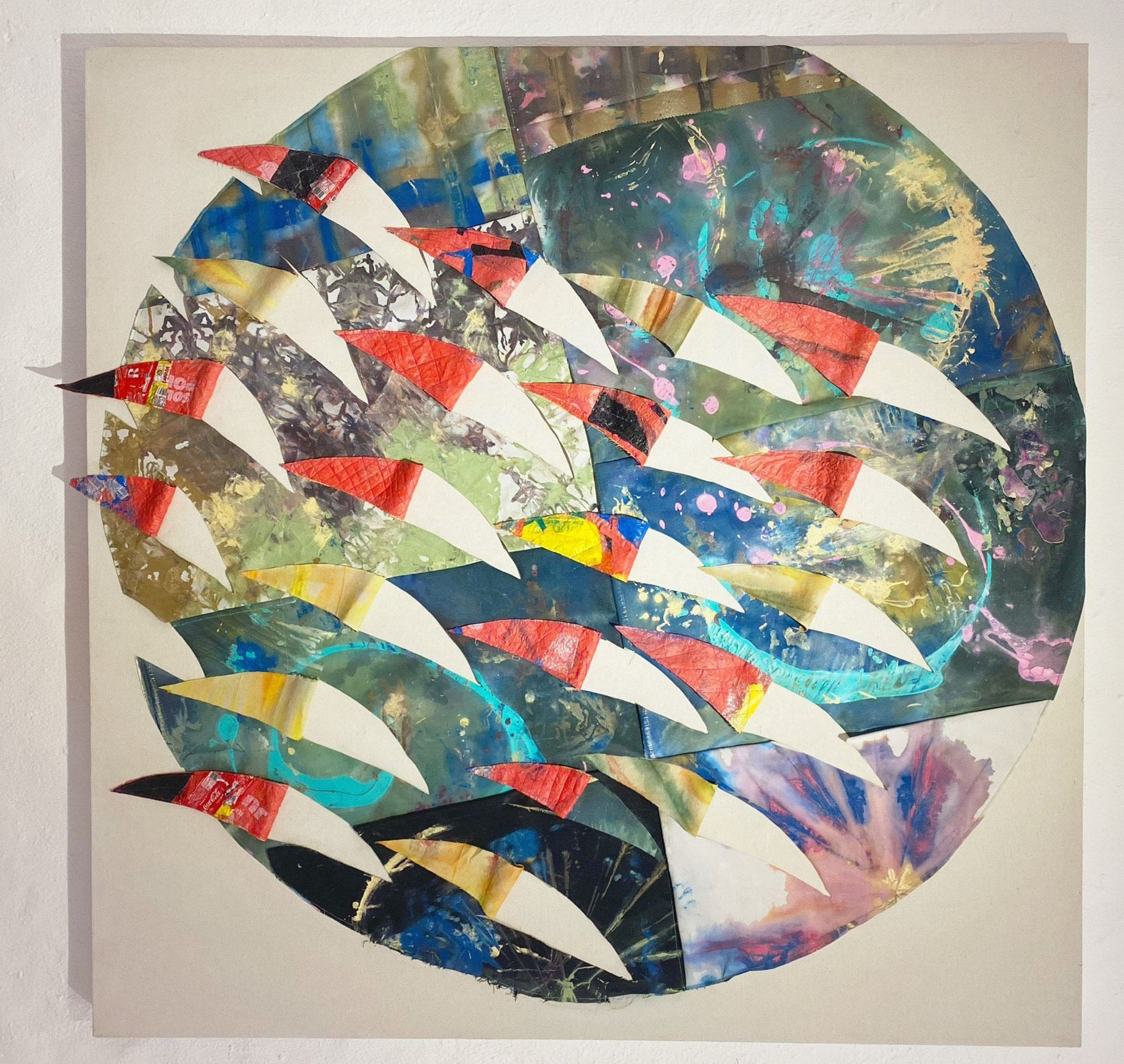Circular collage artwork featuring overlapping curved shapes in various colors and patterns.