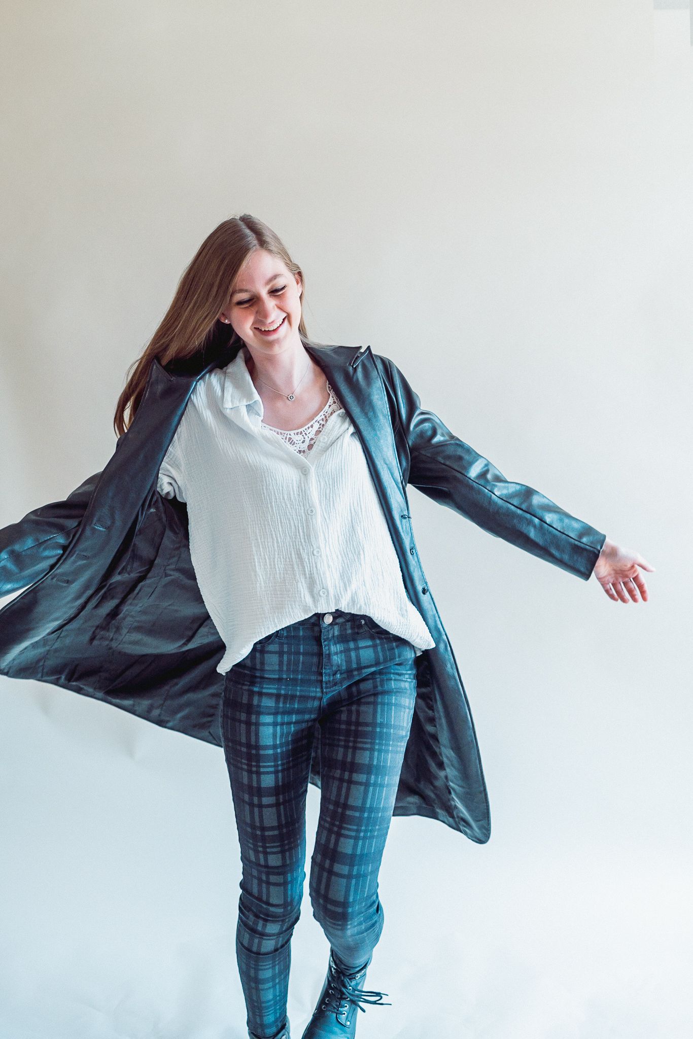 Woman in a leather trench coat spinning in Phoenix Arizona