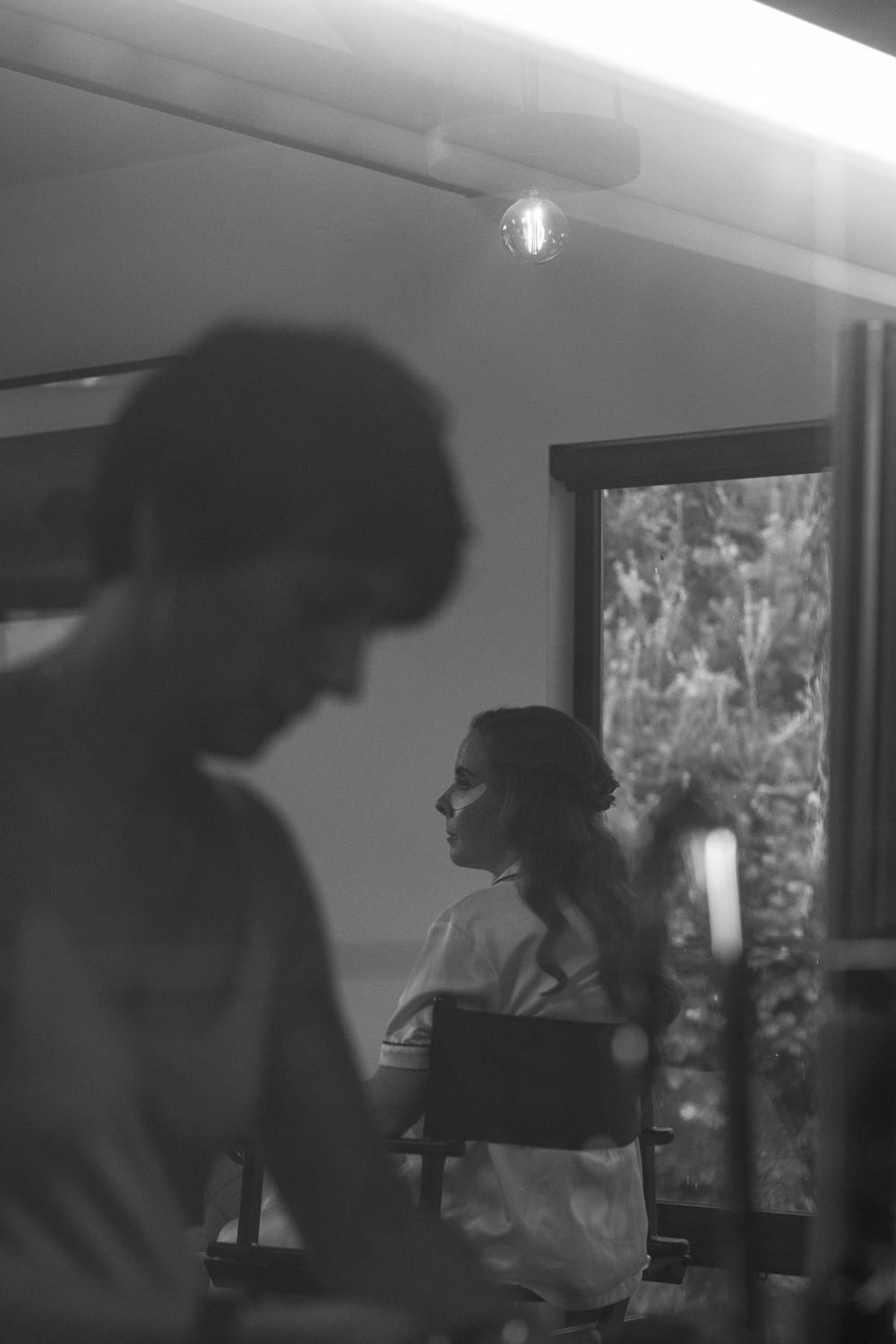 Moody black and white silhouettes in an interior room with natural window light.