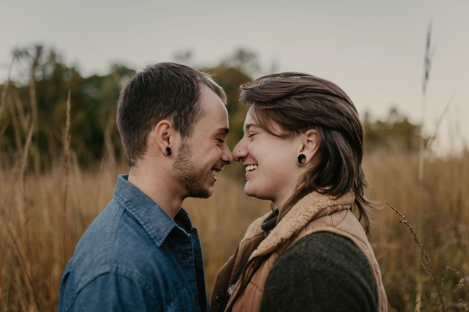 A queer couple in the woods in autumn
