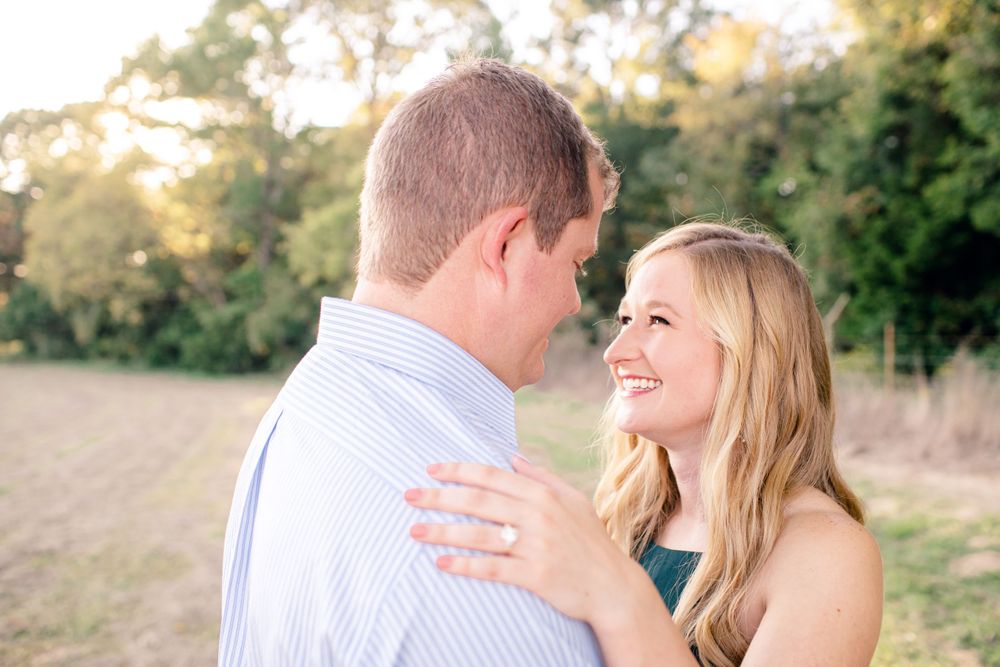 A tender moment between a couple laughing together during an outdoor engagement session.