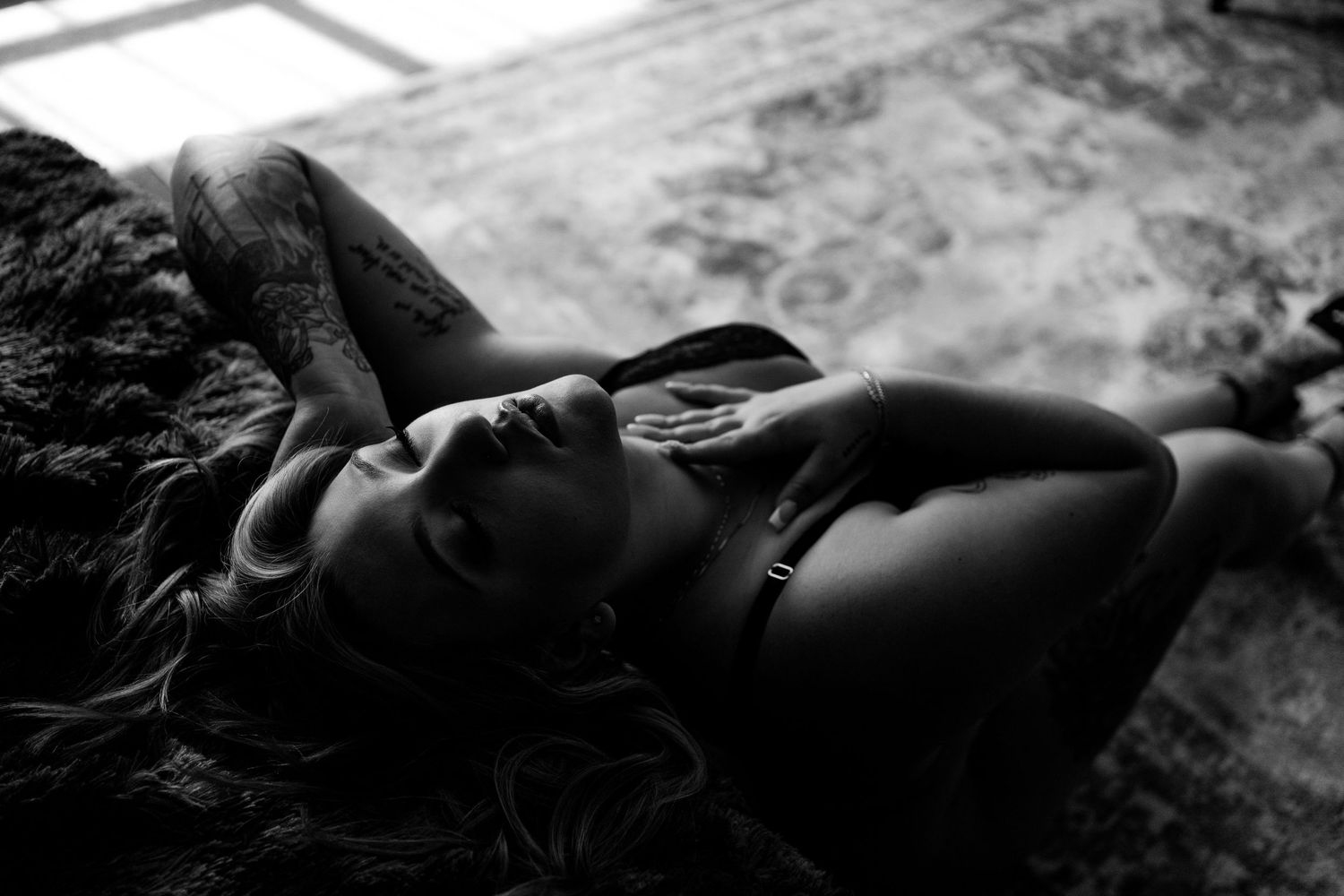 Intimate black and white portrait with soft natural lighting.