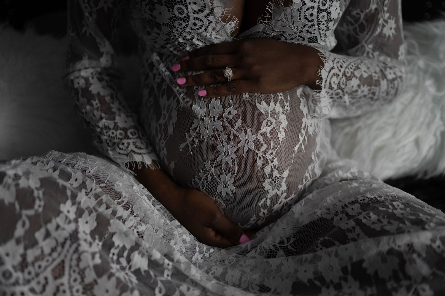 Close-up details of delicate white lace patterns in dramatic lighting.