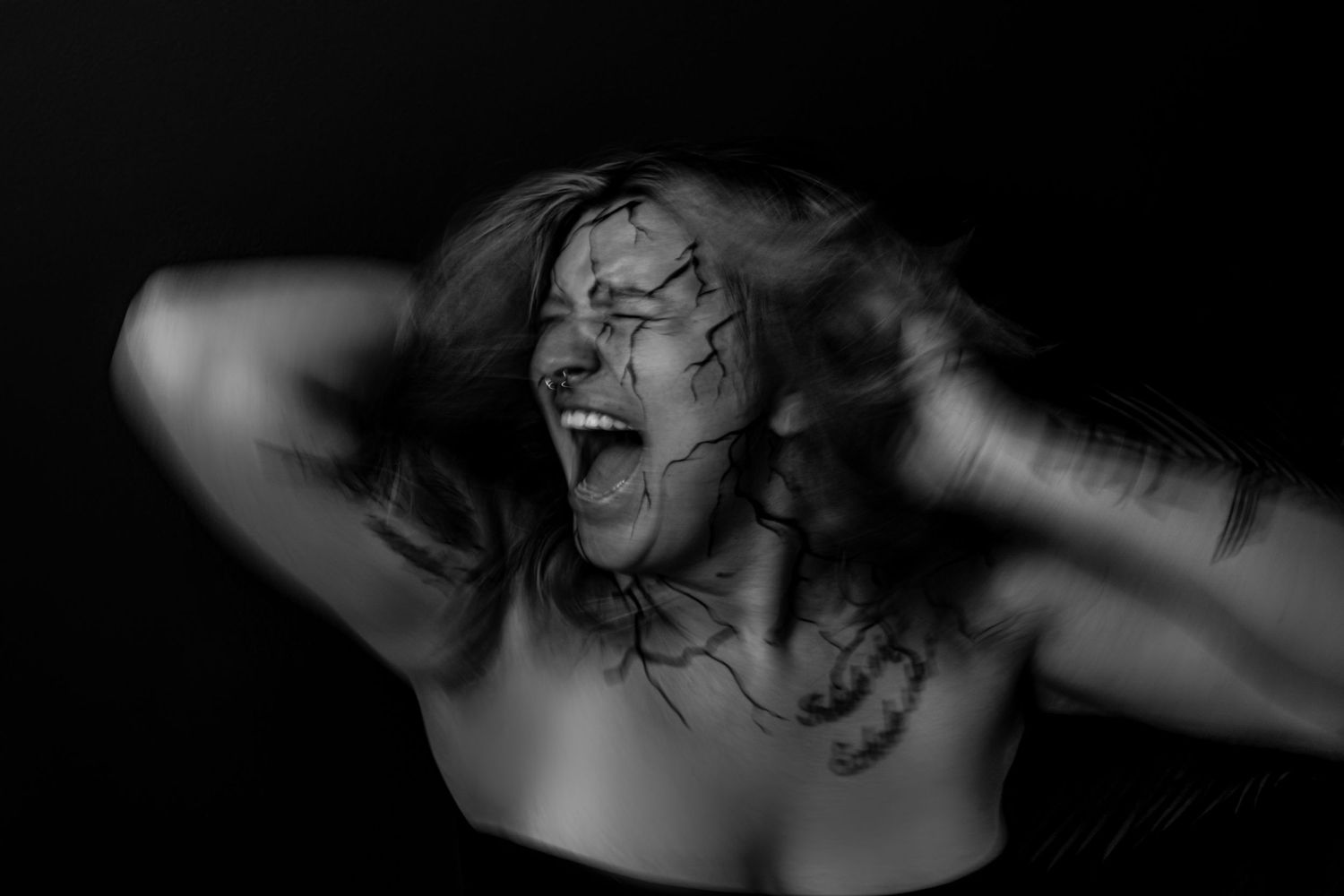 A dramatic black and white portrait series showing emotional expressions.
