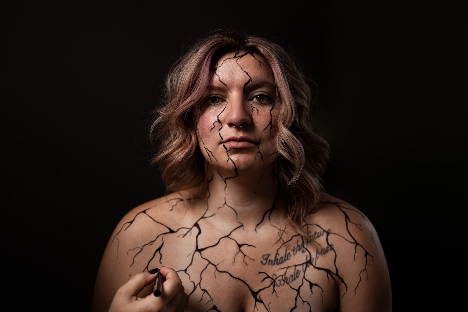 An artistic portrait series featuring dark lighting and branch-like patterns.