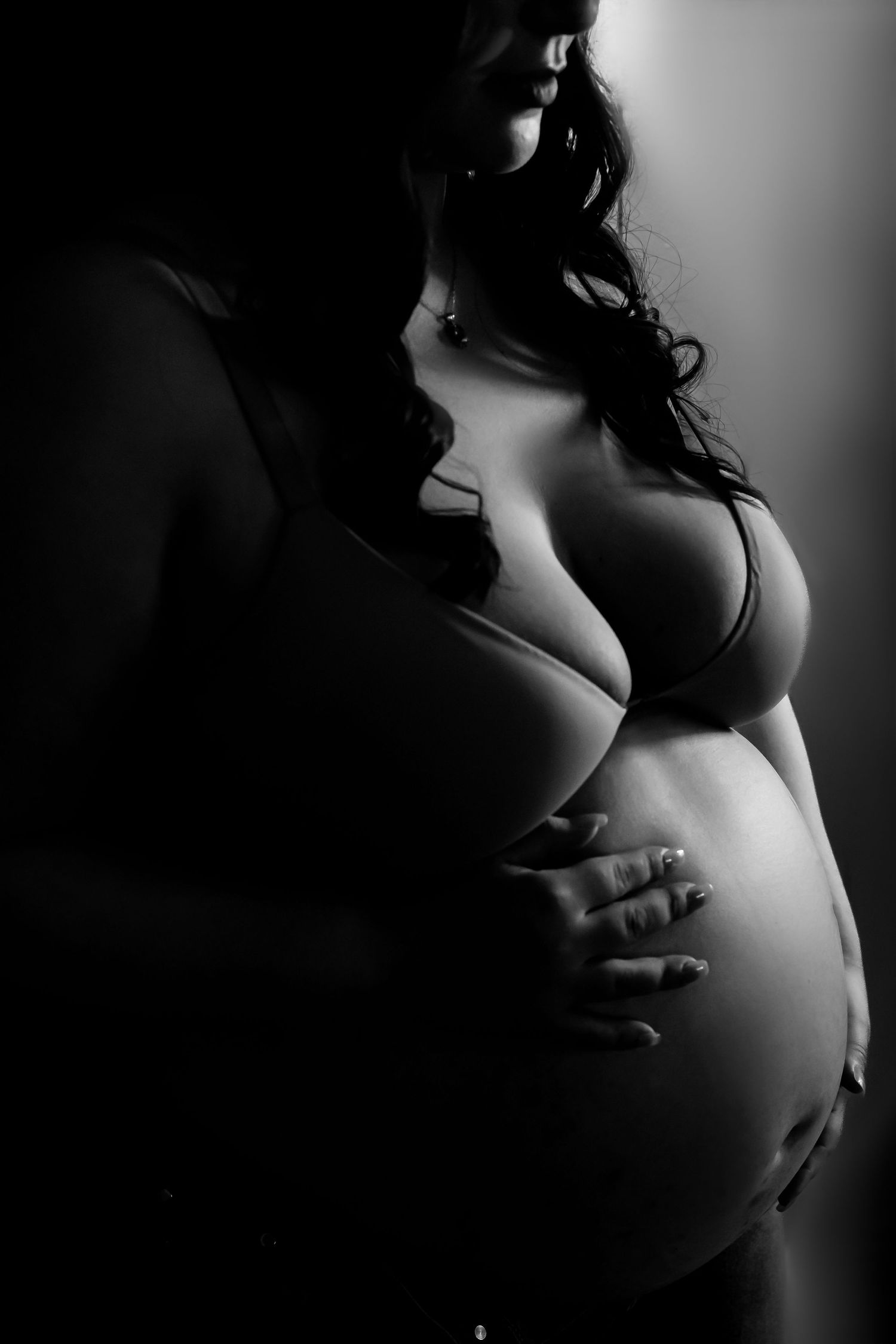 Dramatic black and white silhouette photography with soft lighting and curves.