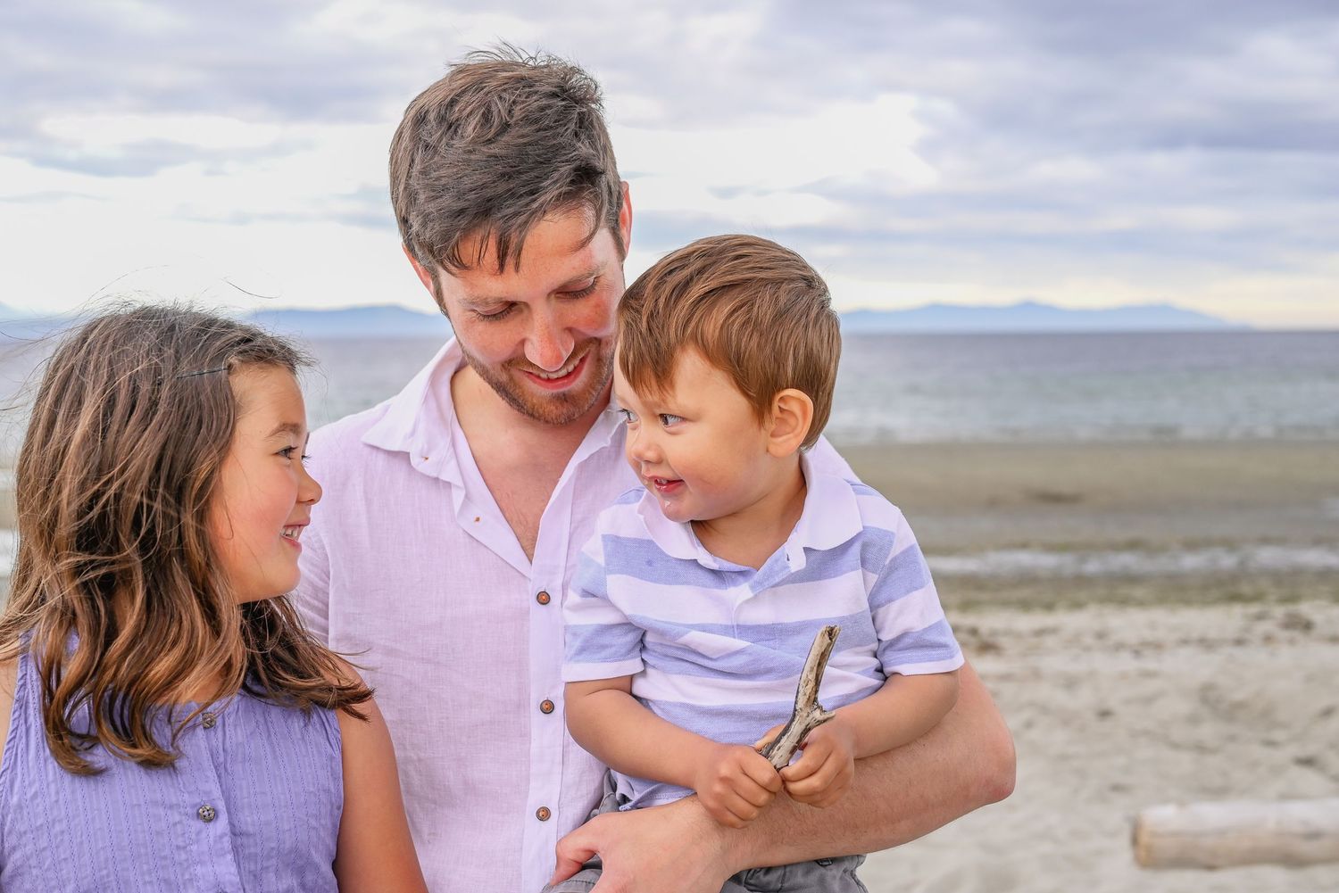 Dad with young son and daughter at the beach