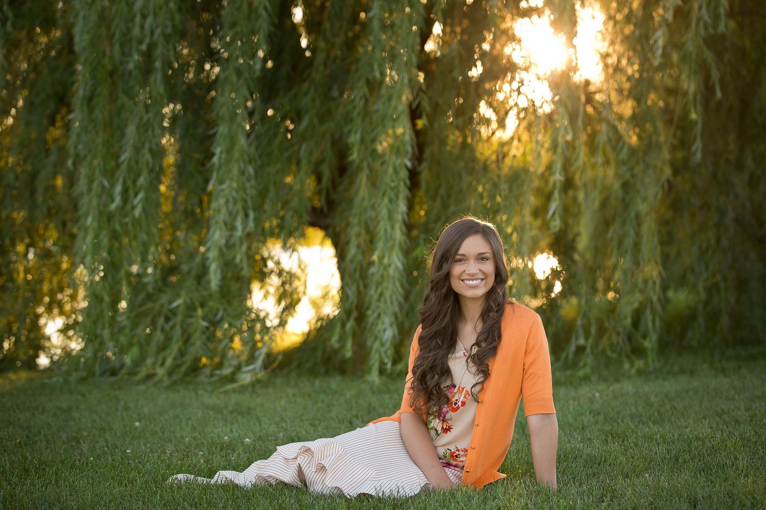 Outdoor portrait series under willow trees during golden hour sunset.