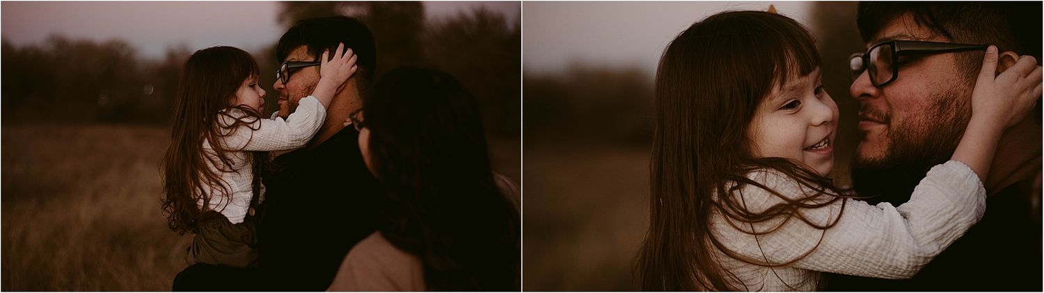 A tender moment captured between two people in a dusky field setting.