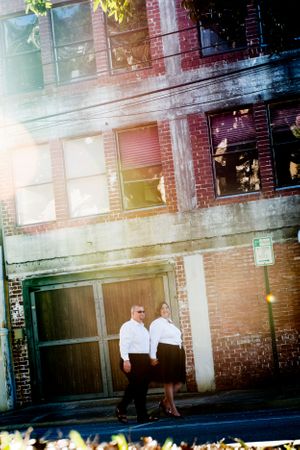couple walking downtown during engagement photoshoot in Panama City Florida