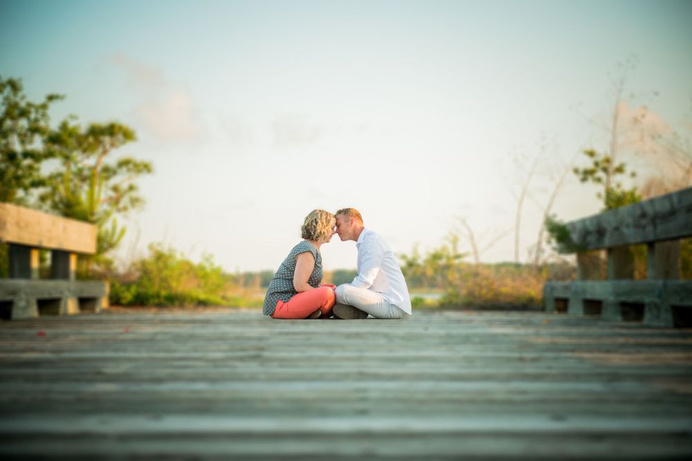 couple sitting on dock during engagement photoshoot in Panama City Florida