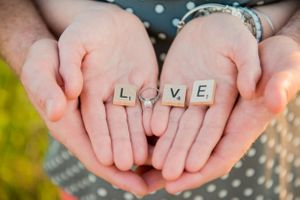 couple holding engagement ring during engagement photoshoot in Panama City Florida