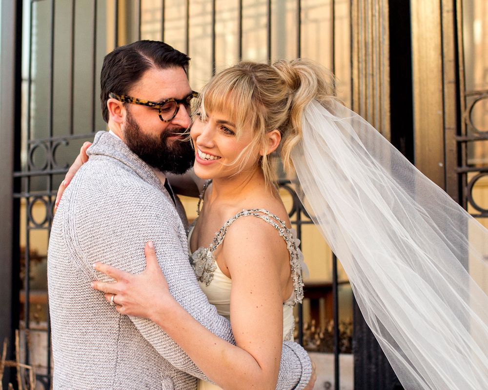 A romantic wedding portrait series featuring the couple against ornate iron gates.
