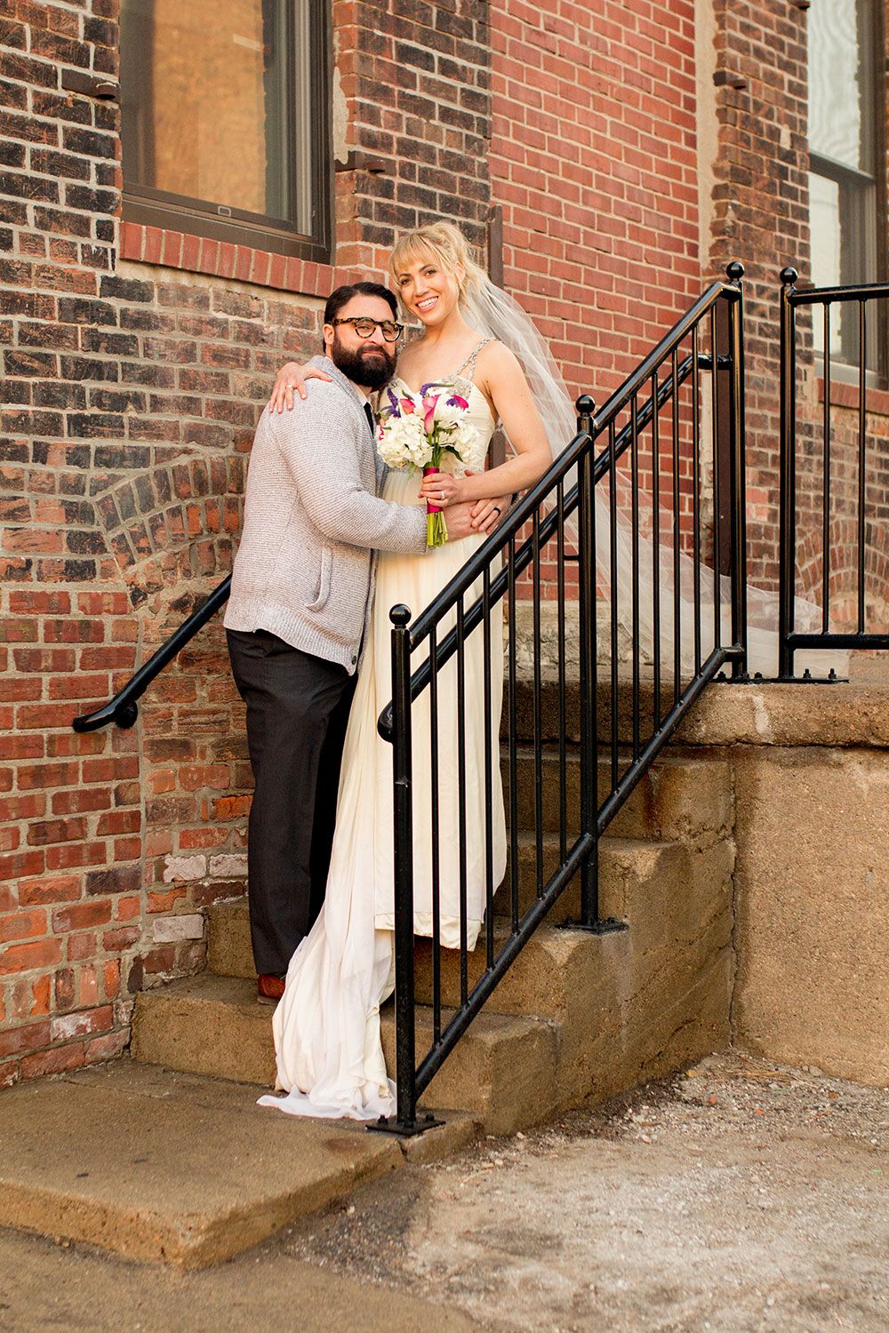 Wedding portraits on brick steps showcase the couple's romantic connection.