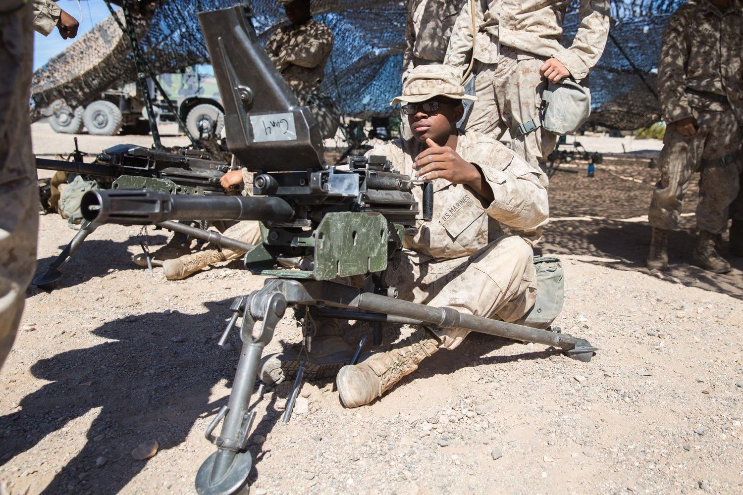 marine working on a gun in the field