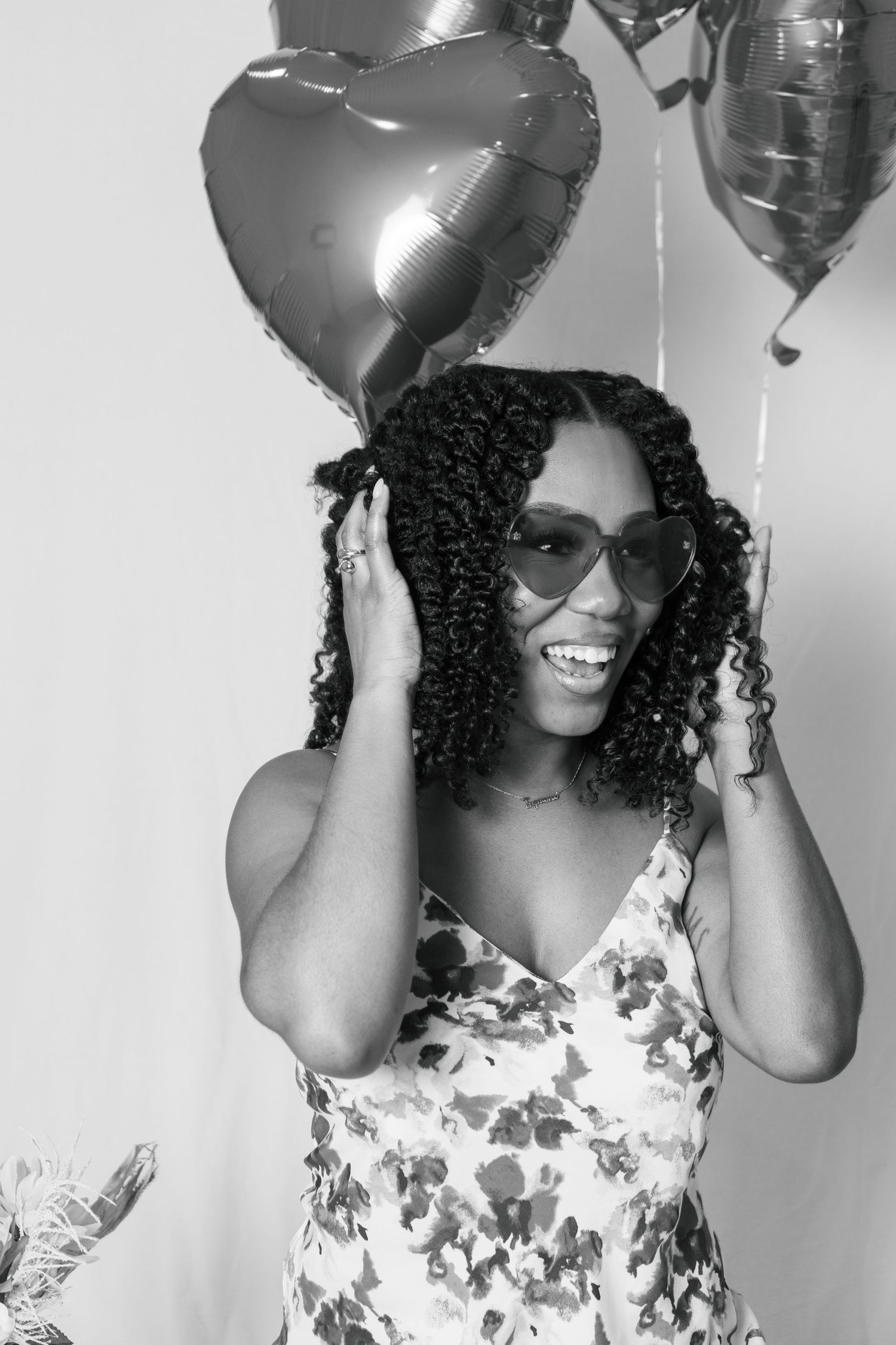 Young woman wearing heart shaped glasses, smiling