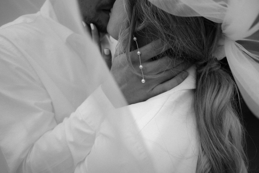 Intimate black and white photograph capturing tender romantic moments between a couple.