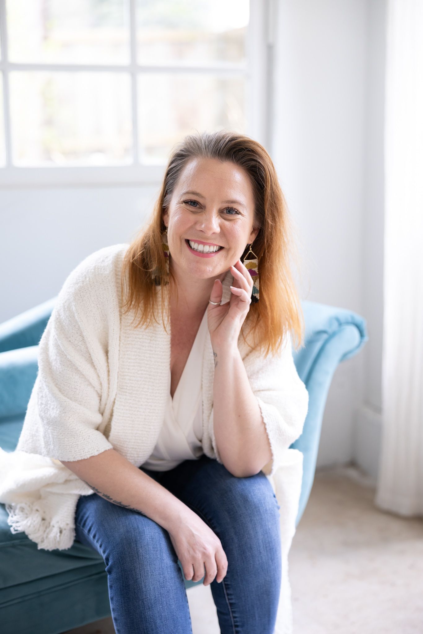 Wild souls interior holistic designer studio in pacific northwest headshot of woman sitting on blue couch