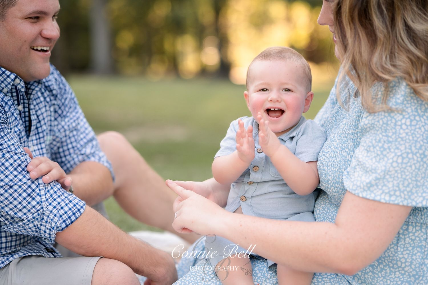 Family shares joyful moment together during outdoor sunset photo session.