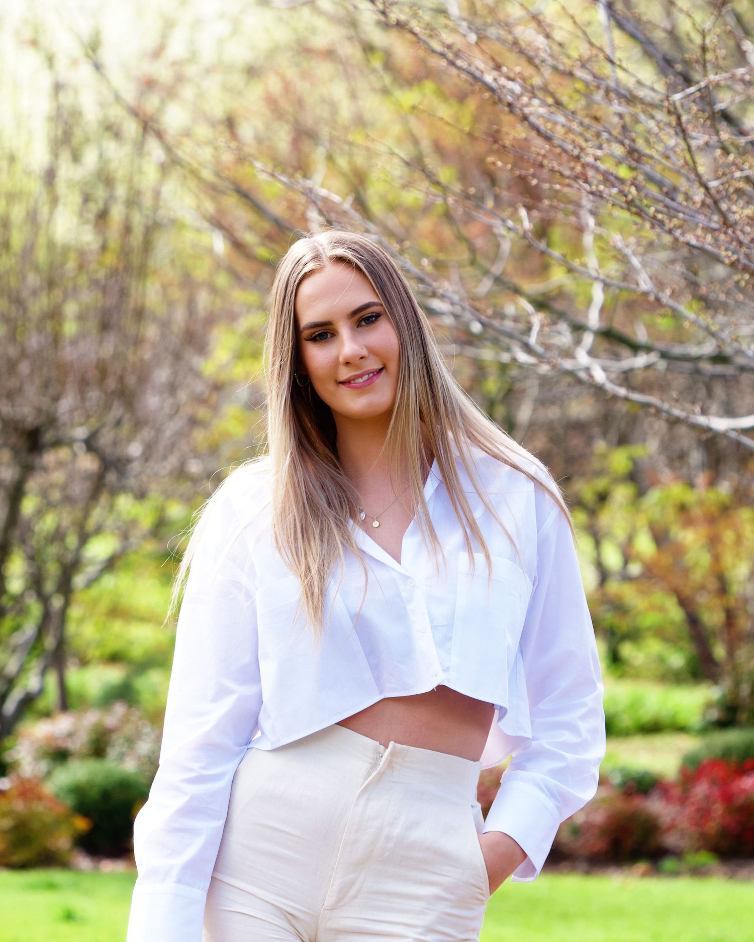 spring portrait of female  wearing white shirt and crream pants on the grounds of the core cider house perth wa