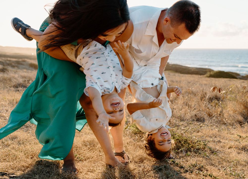 A family photoshoot by Moments With Kell on Oahu in Hawaii with parents and children playing