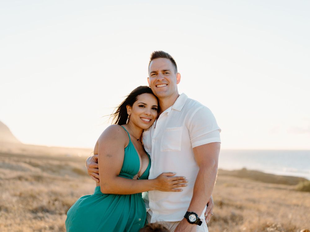 A couples photoshoot by Moments With Kell on Oahu in Hawaii with wife and husband smiling