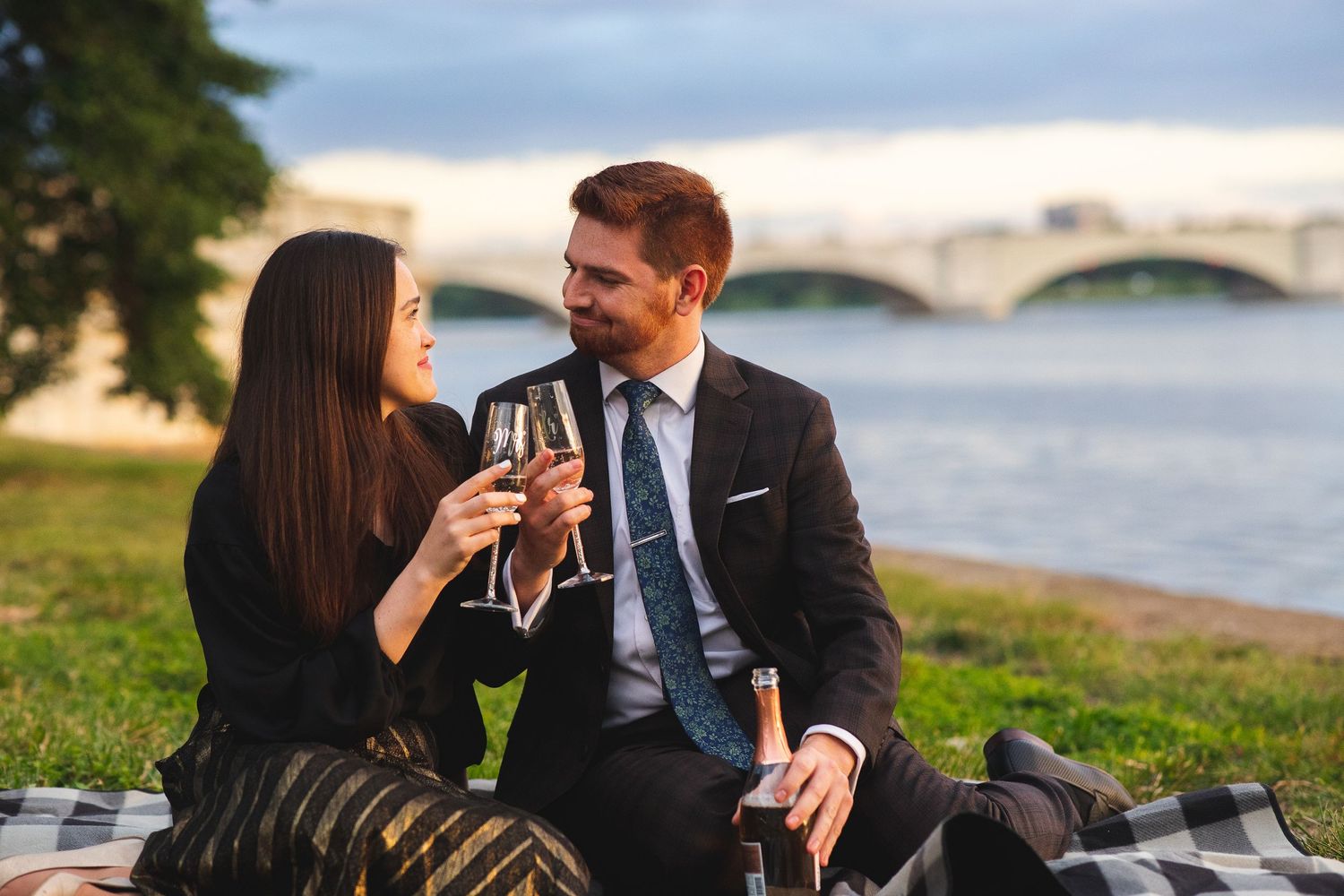 Post-engagement photoshoot champagne cheers by the Potomac River