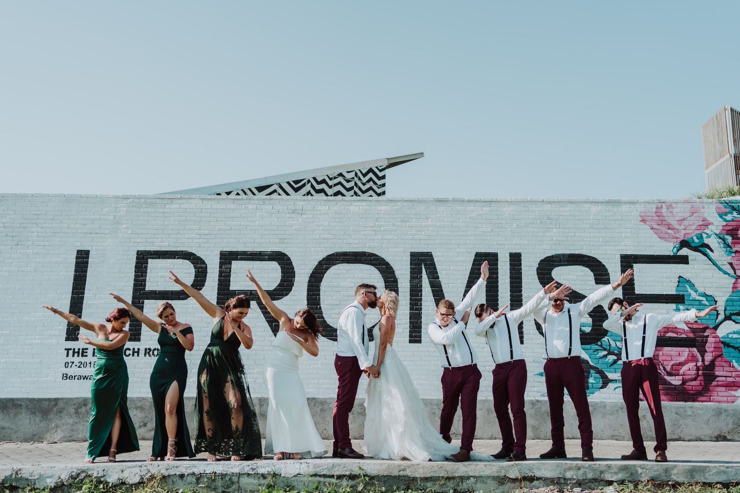 Posing at front of a "I Promise" letters on the wall