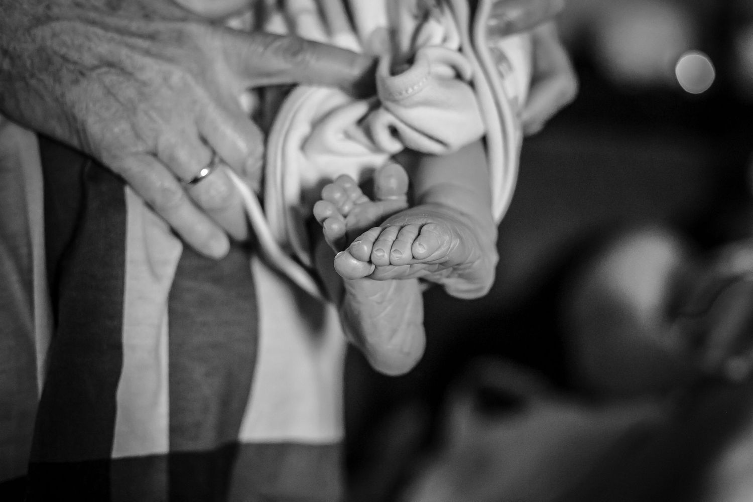 Newborn held by his grandmother just after birth in the family's home near Sioux City, IA.