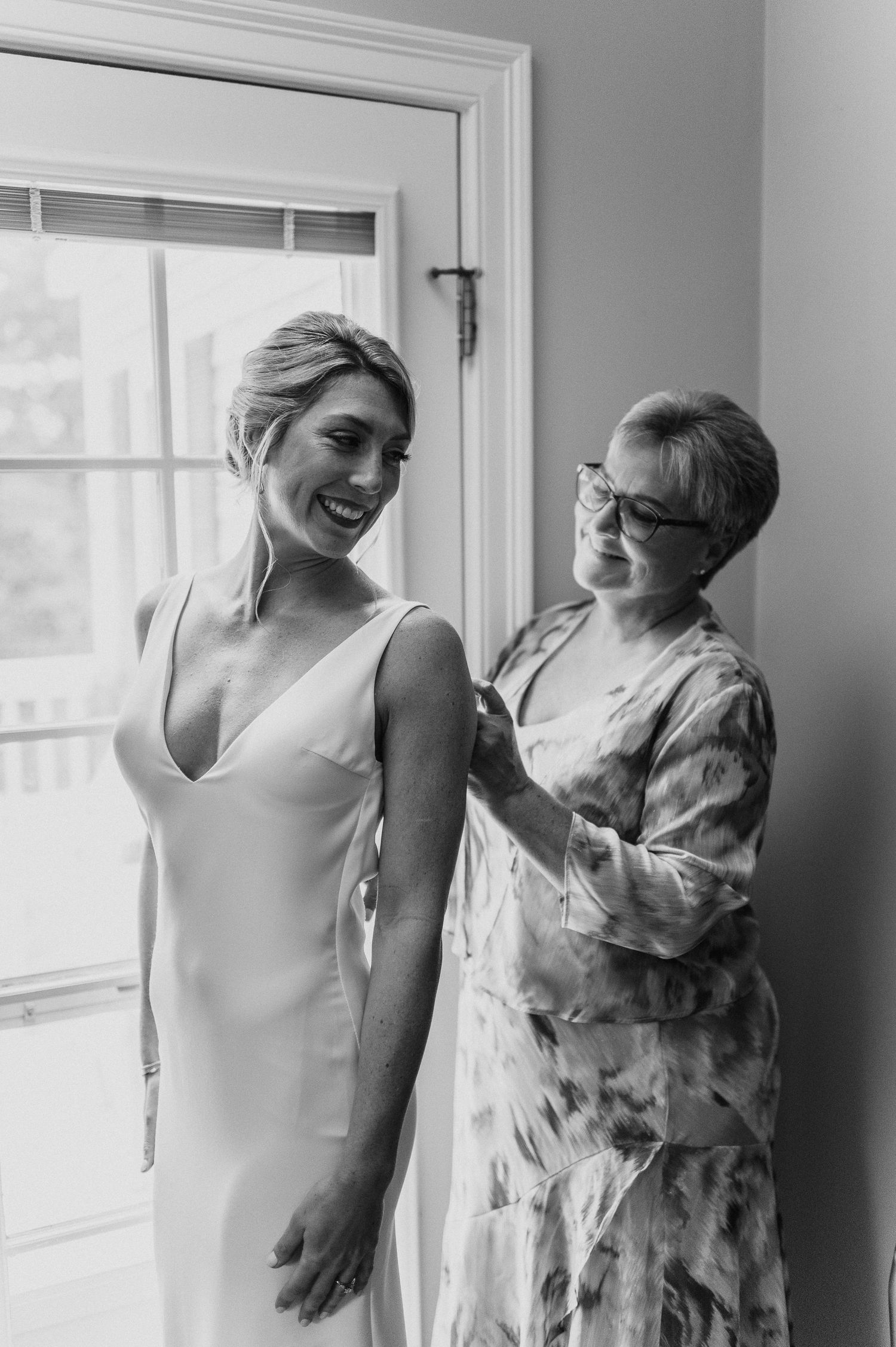 Two people sharing a joyful moment together in a bright interior setting.