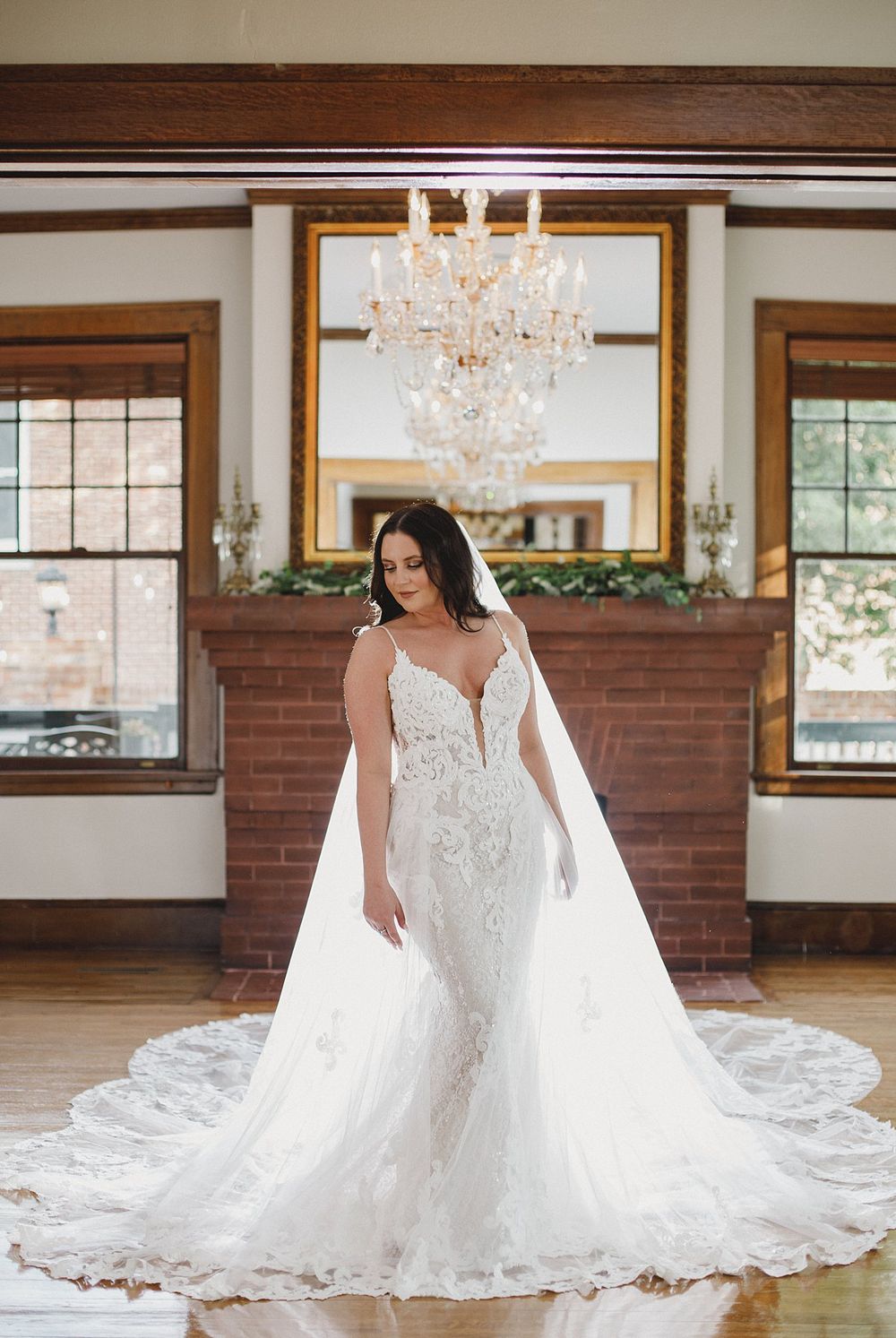 Panoramic sequence showing a beautiful wedding dress with cathedral train in a rustic indoor venue.