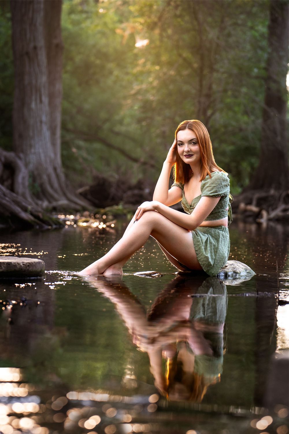 Cibolo Creek Nature Center high school senior girl sitting on rock in creek