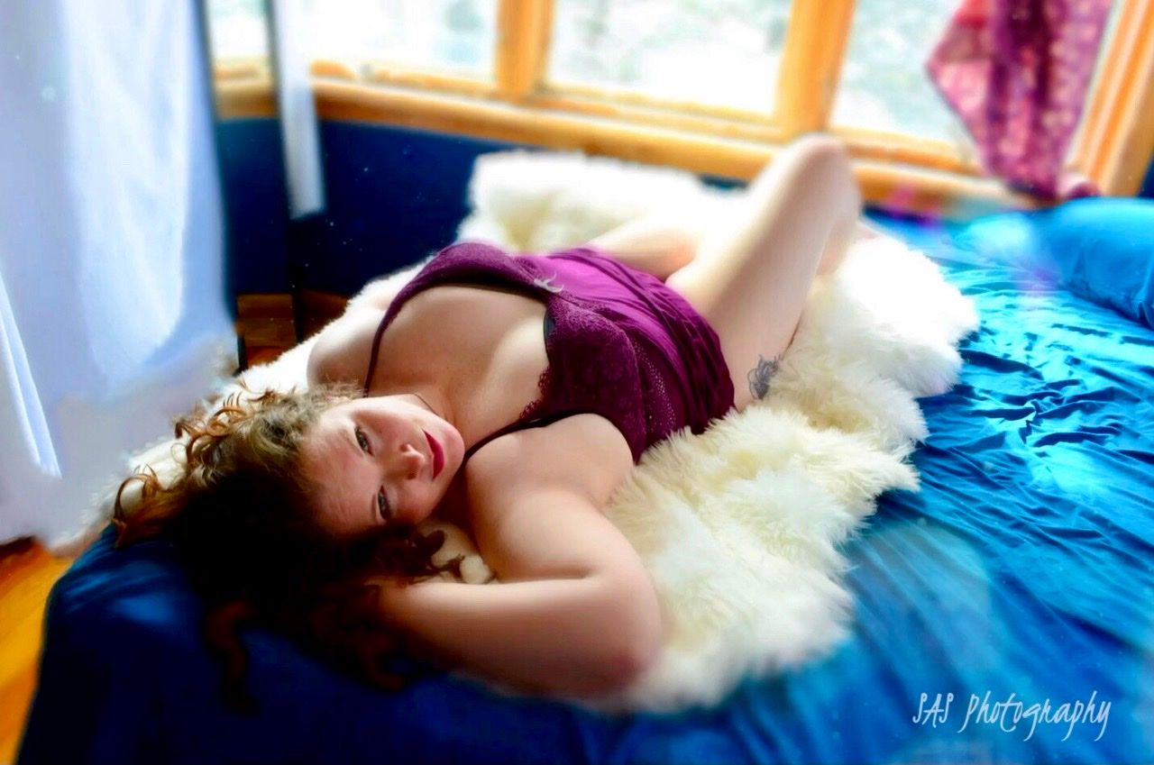 Dreamy bedroom photography with blue tones and natural light streaming through windows.