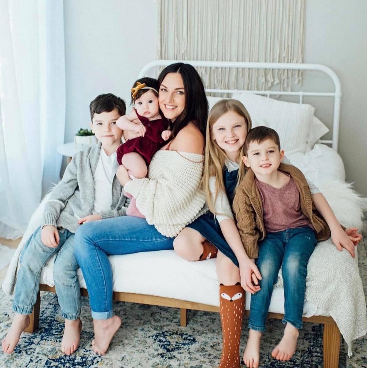 Cozy bedroom gathering on white bed frame with rustic decor.