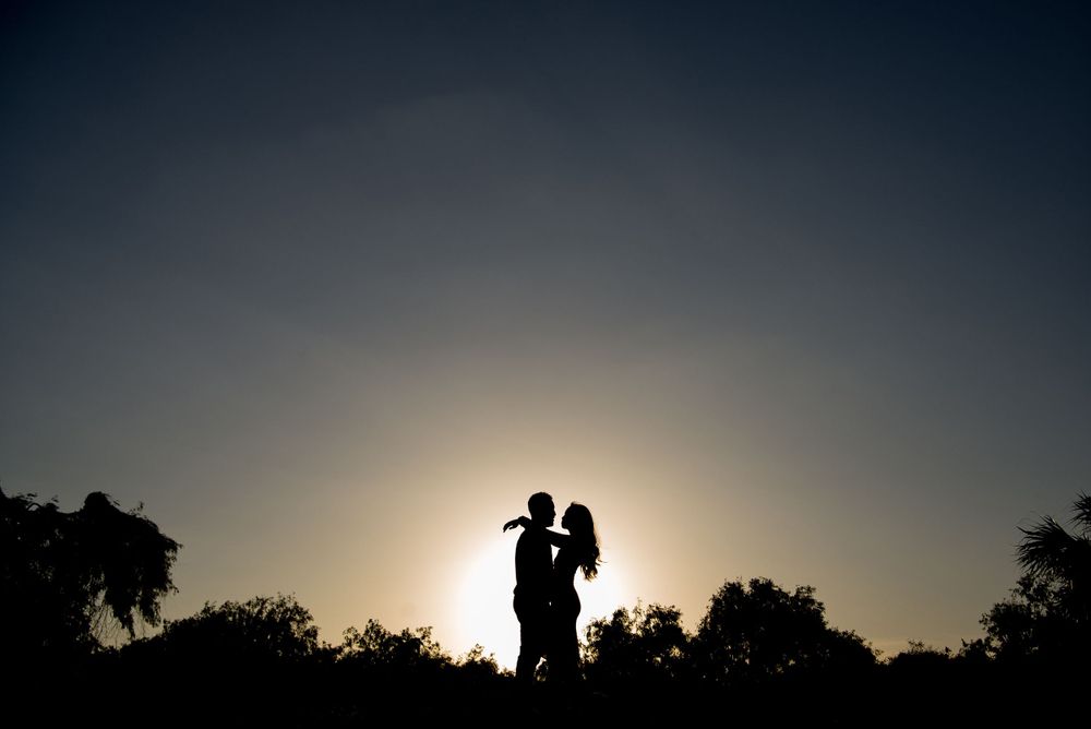 Back like silhouette of a couple kissing and hugging at rancho guadalupe