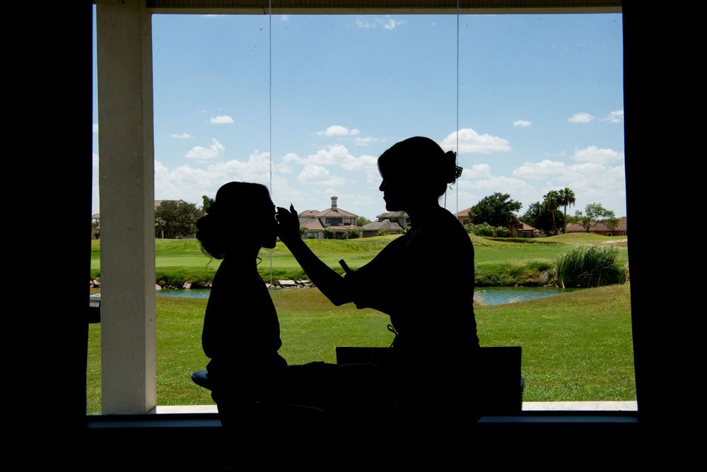 Silhouette of a bribe holding her dress at her Getting ready edinburgh texas