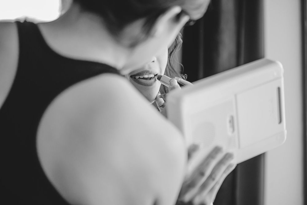 Black and white picture of it Bride getting her makeup done Edinburg texas