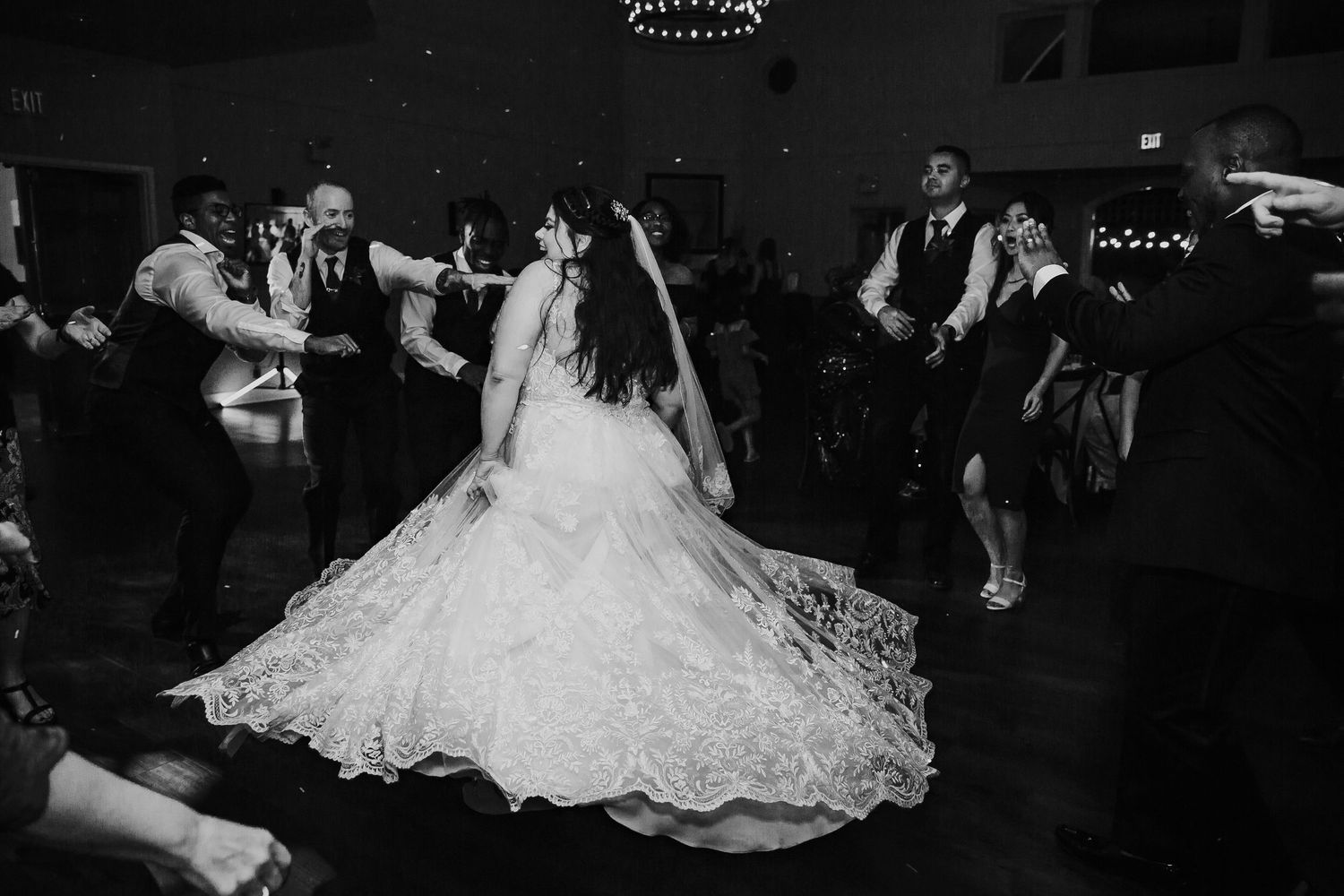 Reception photo of bride dancing i with groomsman in lace gown at wedding at Columbia Winery in Seattle Washington