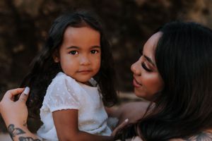 Sweet family moment captured during an outdoor maternity session.