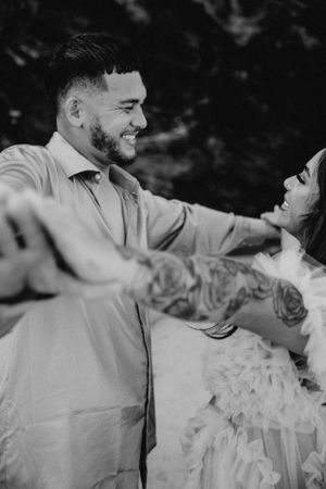 Joyful moments captured in black and white during an outdoor maternity session.