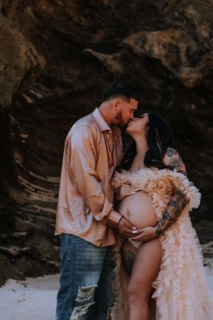 Artistic black and white maternity photos taken against a dramatic coastal backdrop.